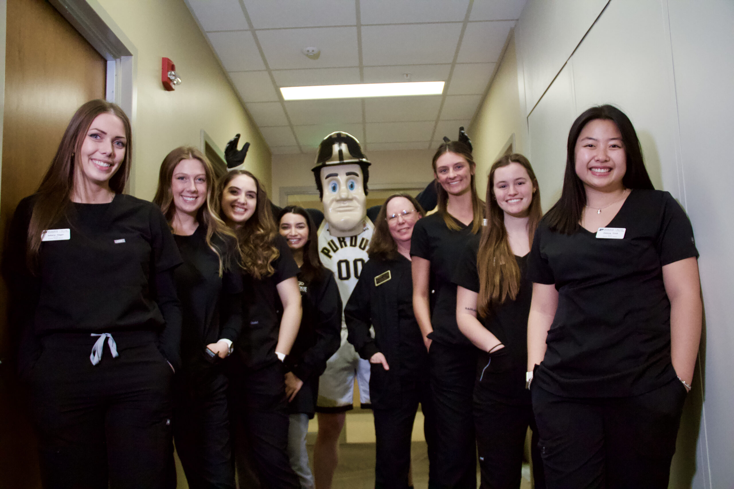 Purdue Pete stands with members of the Purdue audiology program.