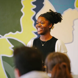 Kyndal Poore speaks in front of a group