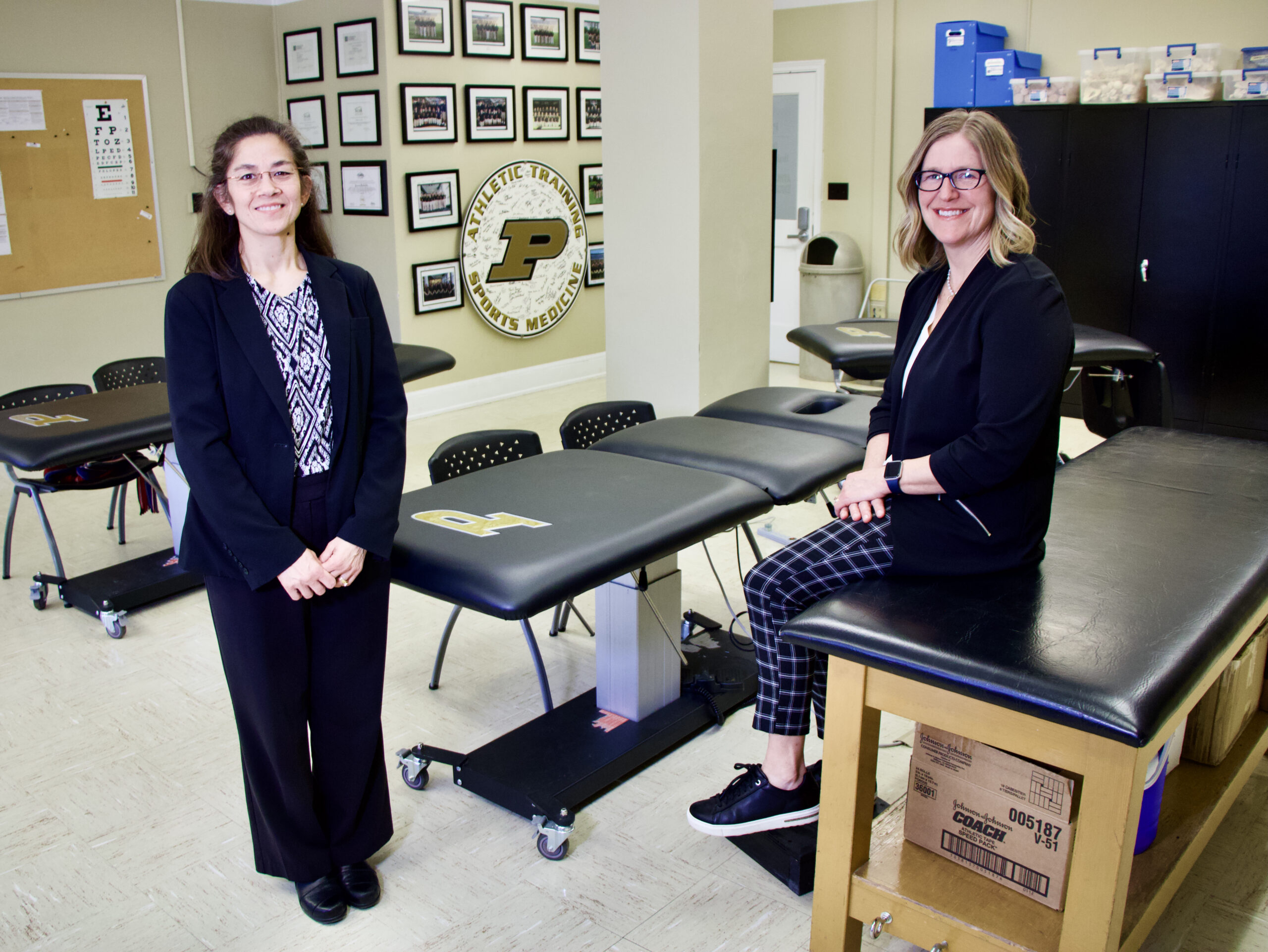 Alice Wilcoxson and Jennifer Popp pose for a picture in a health and kinesiology lab inside Lambert Fieldhouse.