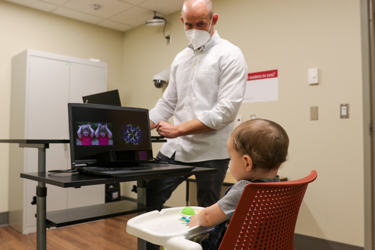 Brandon Keehn works with a young participant in an autism study.