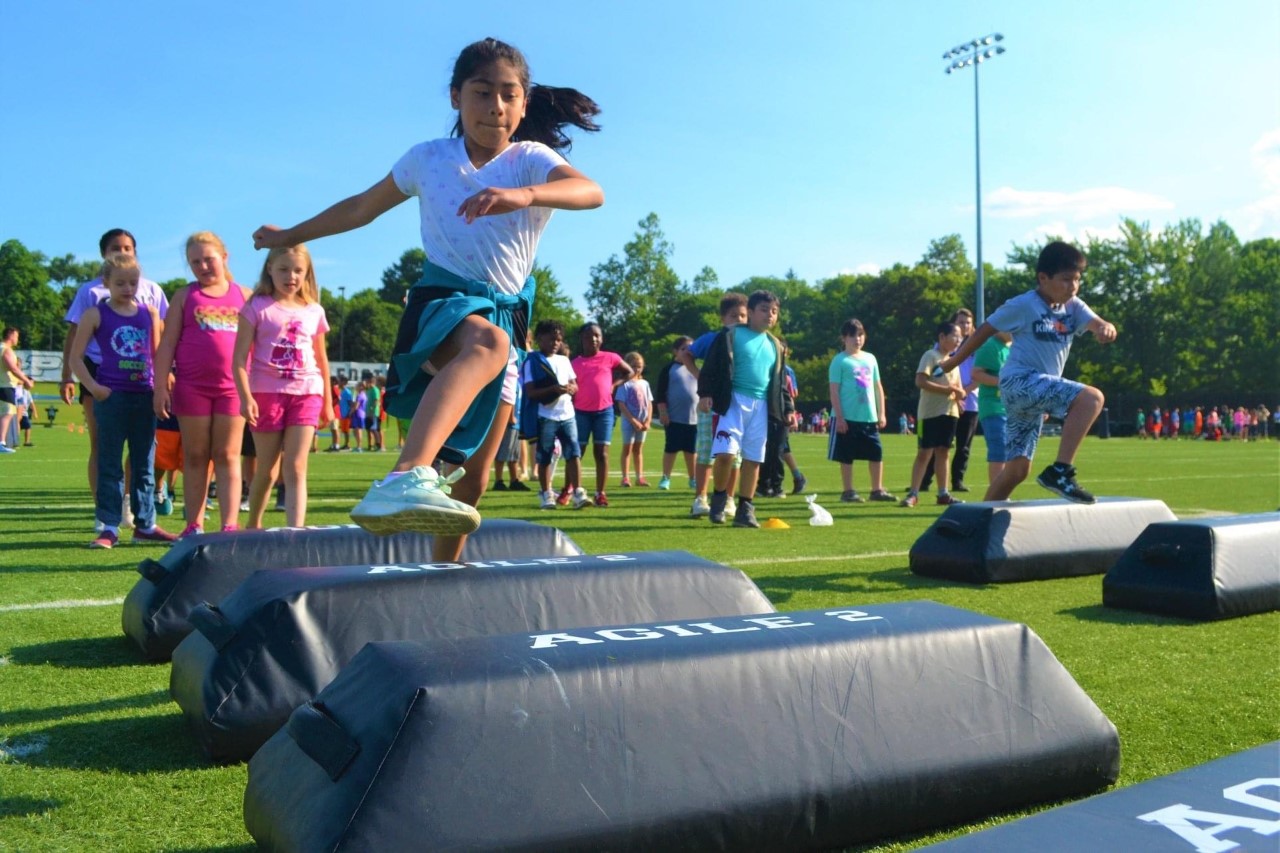 A girl jumps over hurdles