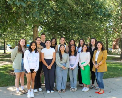 Natalia Rodriguez poses for a photo with her lab group outdoors in Purdue's campus