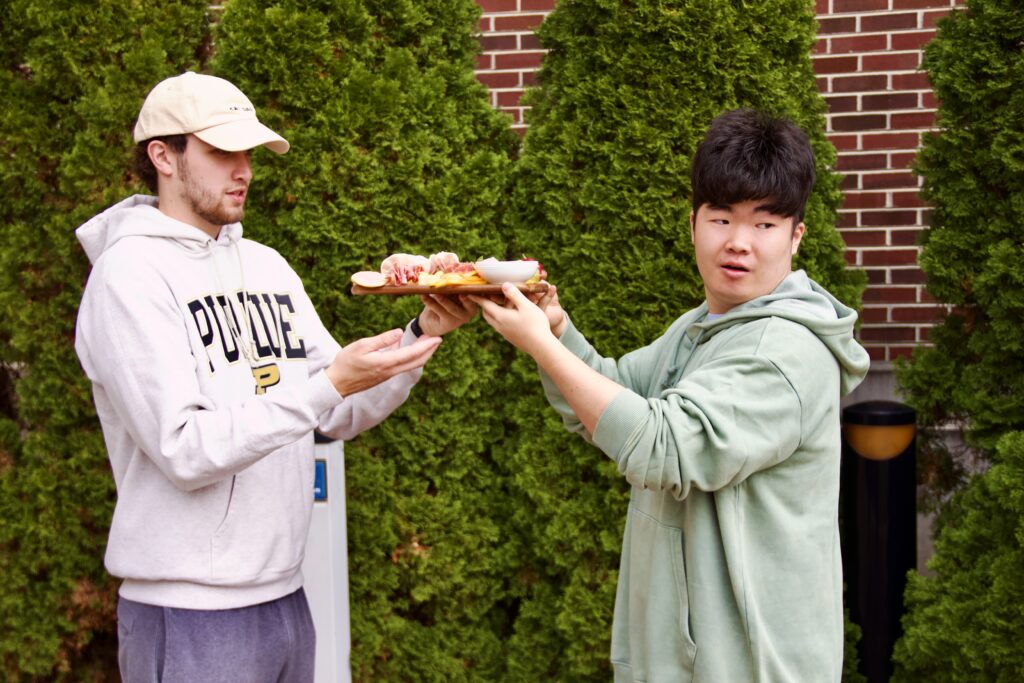 Students escort a charcuterie board outside.