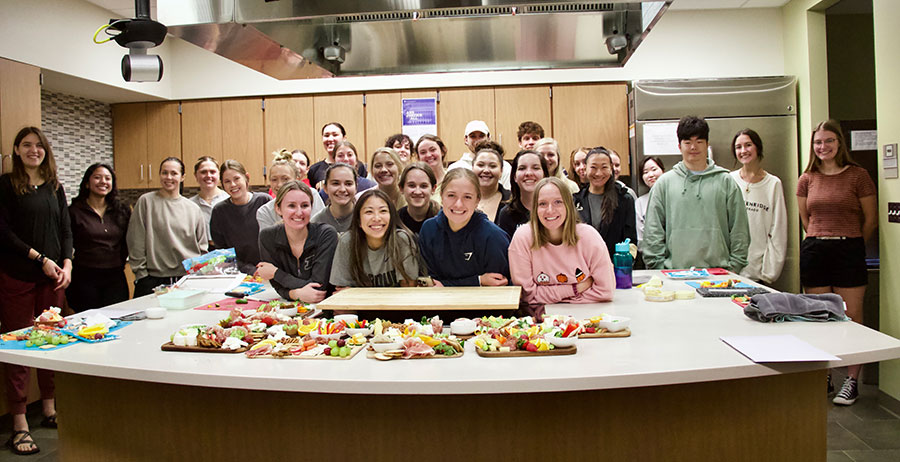 Students pose for a group picture in the Teaching Kitchen.