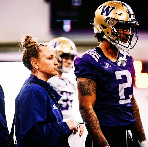 Jaqui Carrell stands on the University of Washington practice sidelines.