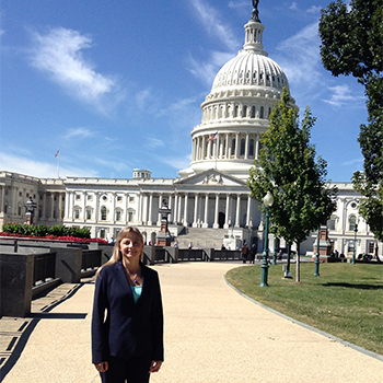 Lynn Adams stands in front of the U.S. Capitol building.