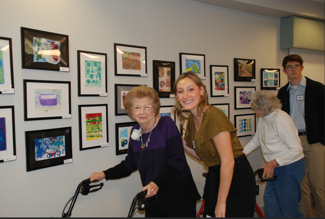 Morgan Lynne Barrette poses for a picture with her art partner in Westminster Village.