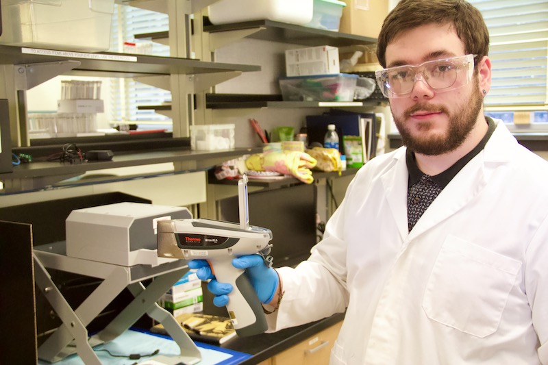 Anthony Bovenschen shows the "gun" part of a x-ray fluorescence machine.