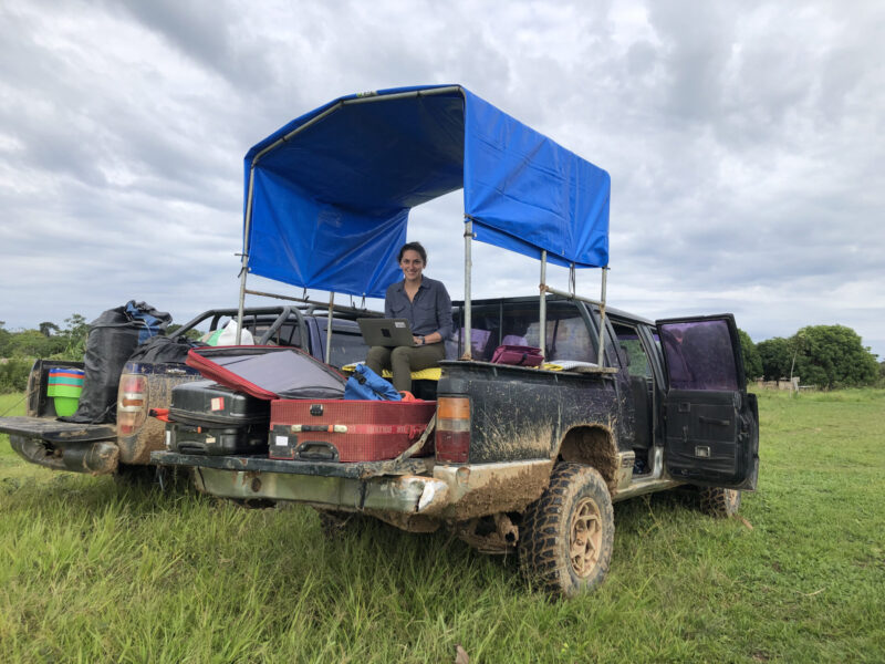 Malinda McPherson sits in the bed of a truck while she conducts research in Bolivia.