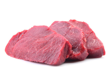 Three cuts of beef steak rest on a white background