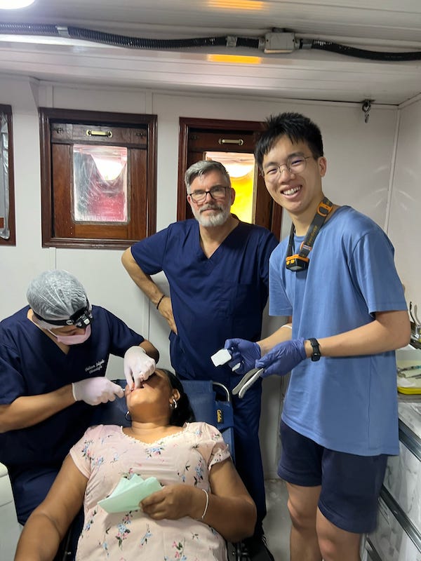 Joseph Chen assists dentists in Brazil during a high school mission trip.