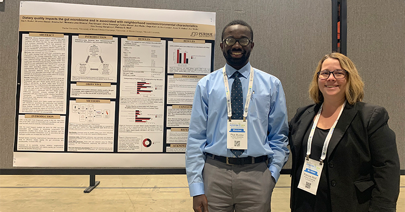 Pius Sarfo Buobu stands with Patricia Wolf in front of a research poster.
