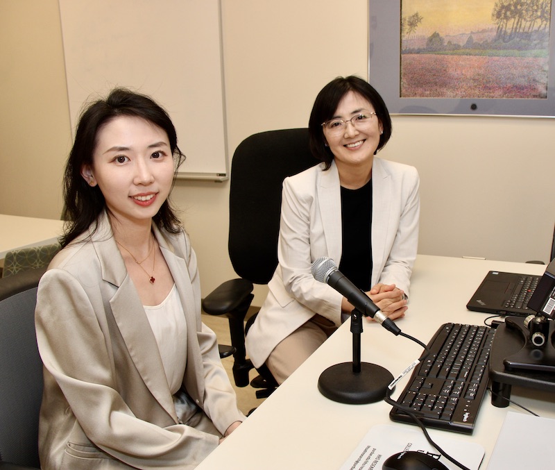 Peng Zhang and Jiyeon Lee sit at a computer station.