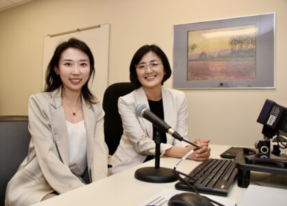 Peng Zhang and Jiyeon Lee pose for a picture in the Purdue Aphasia Lab.