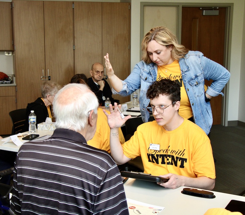 A graduate student works with a Parkinson's patient as Lydia Kruse advises.