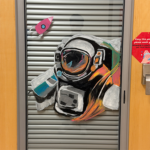 An astronaut and rocket are drawn on a hospital window.