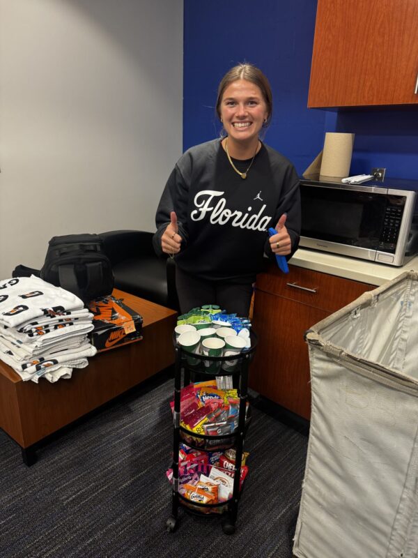 Julia Skinner gives a double thumbs up while organizing snacks.