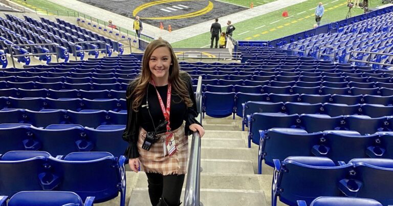 Taylor Bilger stands near the Lucas Oil Stadium football field.