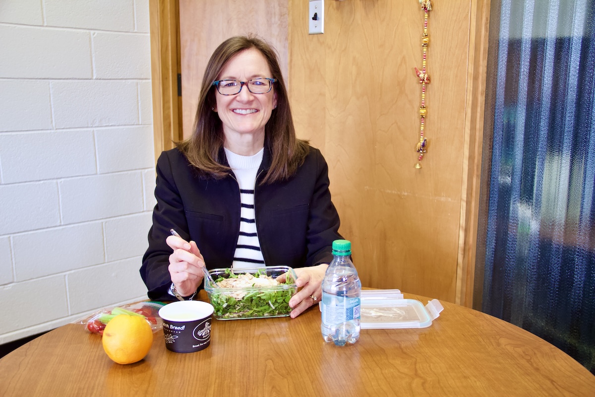 Laura Murray-Kolb sits down to her lunch in her office.
