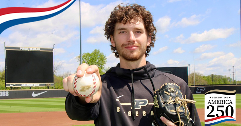 Joe Trenerry holds a Purdue baseball toward the camera at Alexander Field