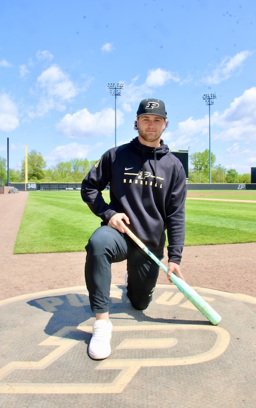 Aaron Manias takes a knee on the Alexander field on-deck circle.