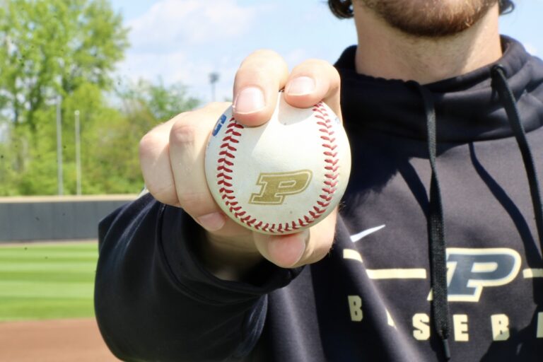Joe Trenerry holds a Purdue baseball for a picture at Alexander Field