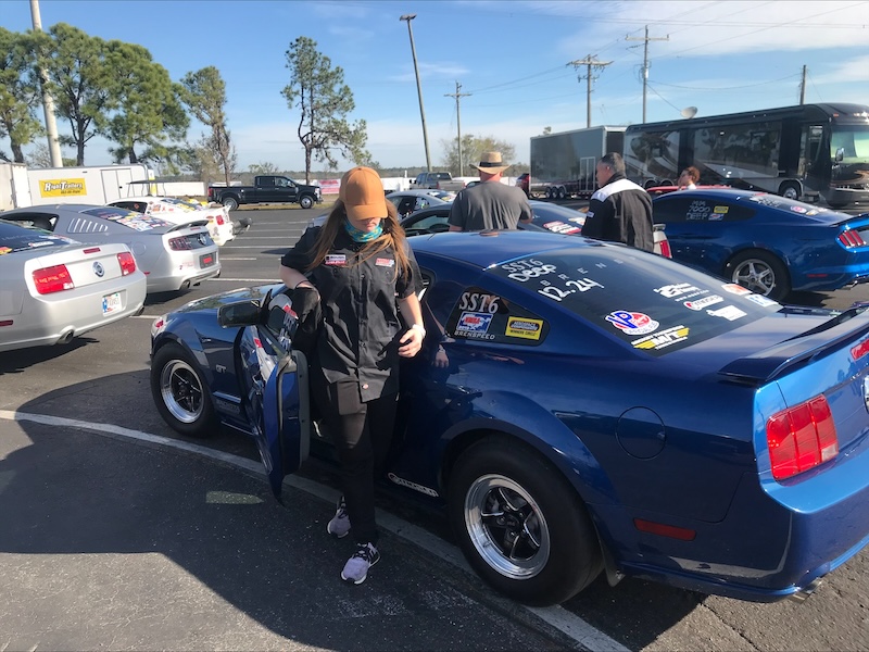 Molly Wendel steps out of her Mustang after a drag race. 