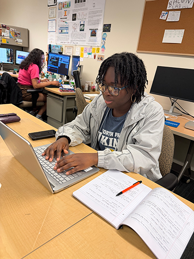 Blessing Klevor works on a laptop in the Baloni Lab.