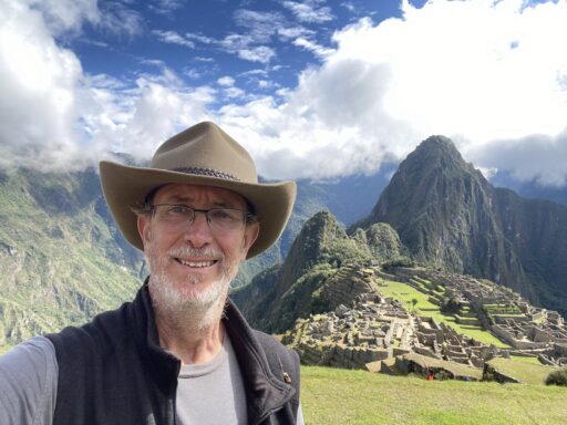 Jonathon Day stands in front of Machu Picchu in Peru for a photo.