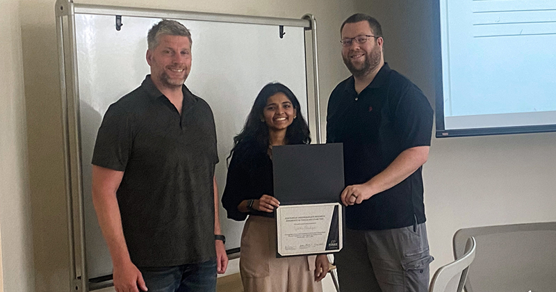 Vidhi Pandya receives her PURE Tox certificate from Jonathan Shannahan and Jason Cannon