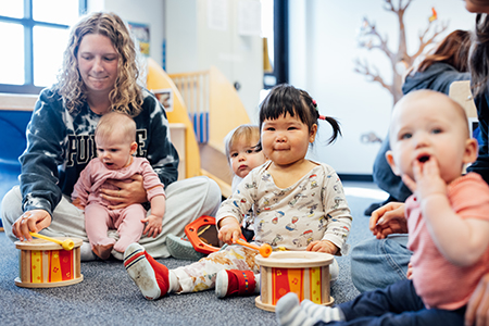 Infants play with instruments in the lab school.