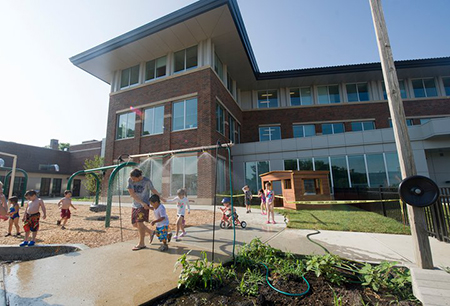 Kids play outside of Hanley Hall.