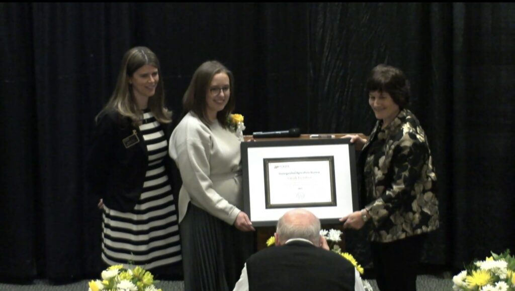 Sarah Leaskey Receives Large Plaque from Purdue Agriculture Dean, Karen Plaut
