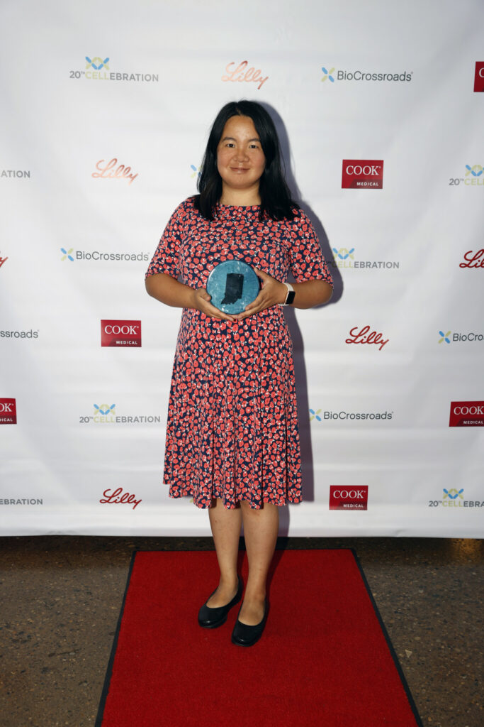 Ying Li holding the 23 Pair Award