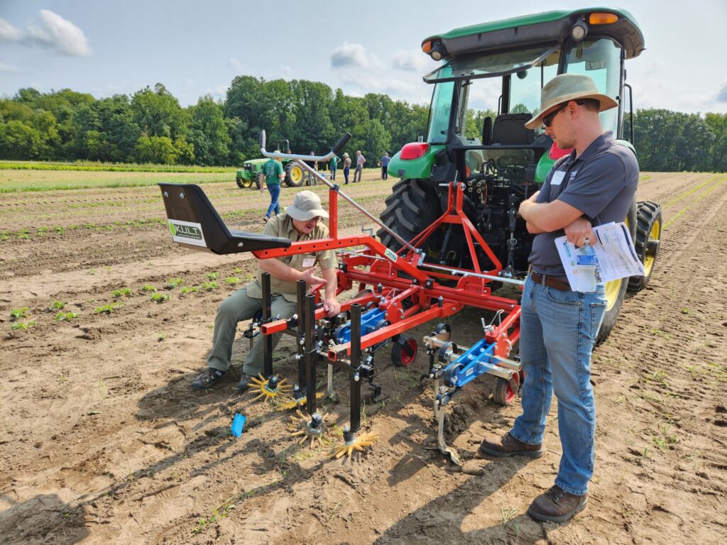 Stephen Meyers observing a tractor hitch for mechanical weeding