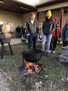 students standing around a fire pit
