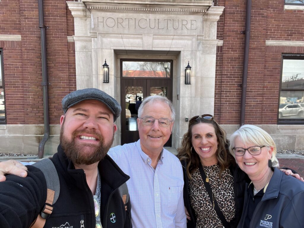 Dustin Potts, Dr. Mike Dana, April Shepherd, and Robin Tribbett posing for a selfie in front of the HORT building.
