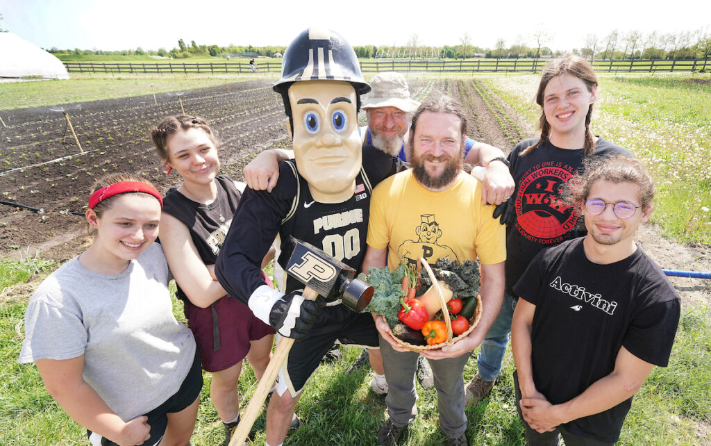 Sophia Mears, Nellie Walthery, Robert Leucke, Purdue Pete farm manager Chris Adair, Wil Brown-Grimm, and Alfonso Rosselli standing outside at the Purdue Student Farm.