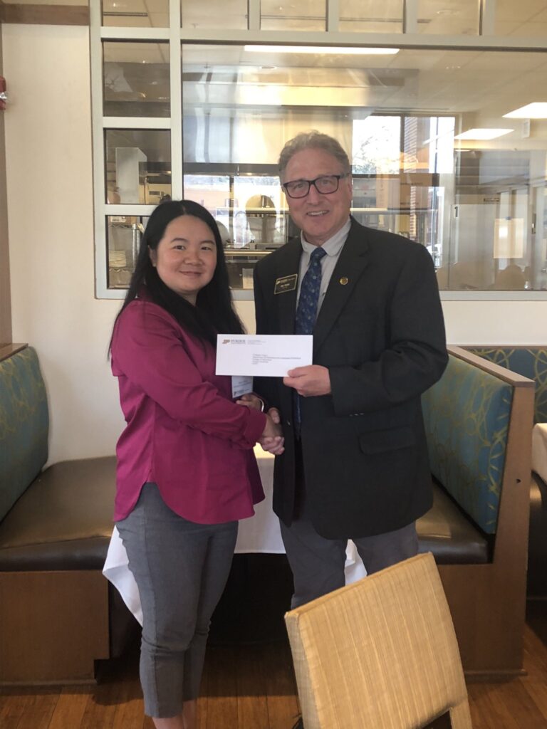 Purdue College of Ag Interim Dean Dr. Ken Foster presenting promotion letter to Dr. Ying Li.