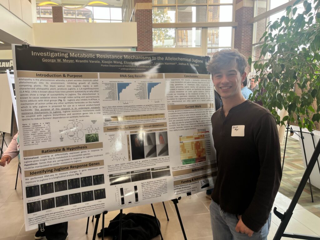 George Meyer standing with his poster presentation.