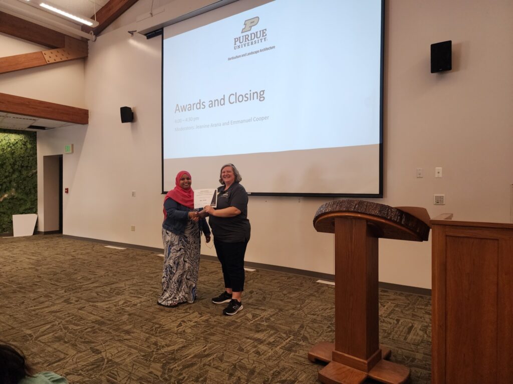 Dhuha Mohamed receives 2nd Place Masters Research Posters Travel Grant Award from Linda Prokopy.