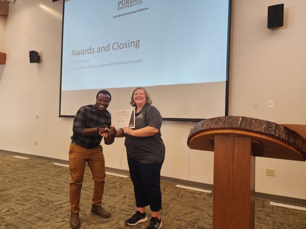 Emmanuel Cooper receives 1st Place Masters Research Posters Travel Grant Award from Linda Prokopy.