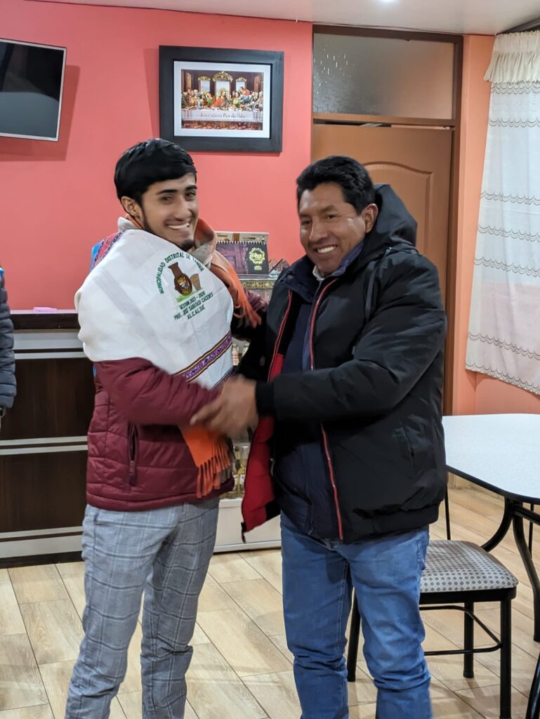 Cristian Salinas receives a typical local garment from the Jose Saryasi (Mayor of Yanque) in appreciation for the visit and new partnership.