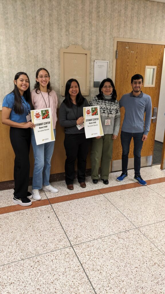 Marian Luis, Cristian Salinas, Ada Martinez, Naomy Perez, and Sara Cruz standing outside a the presentation room for the conference in Stewart Center.
