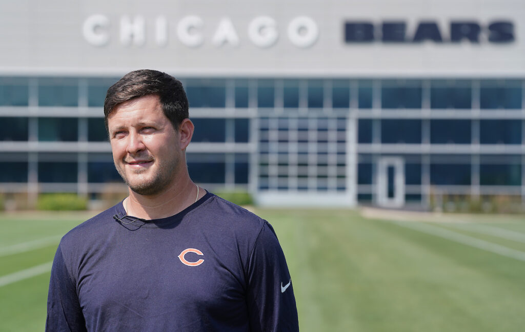 Ben Baumer standing in front of the Chicago Bears Training Center building.