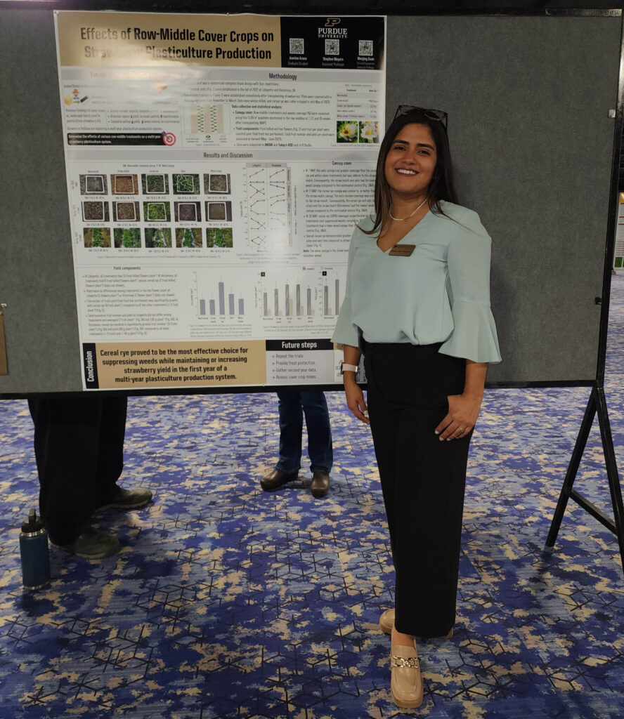 Jeanine Arana standing in front of her research poster.