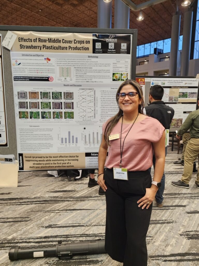 Jeanine Arana standing in front of her research poster.