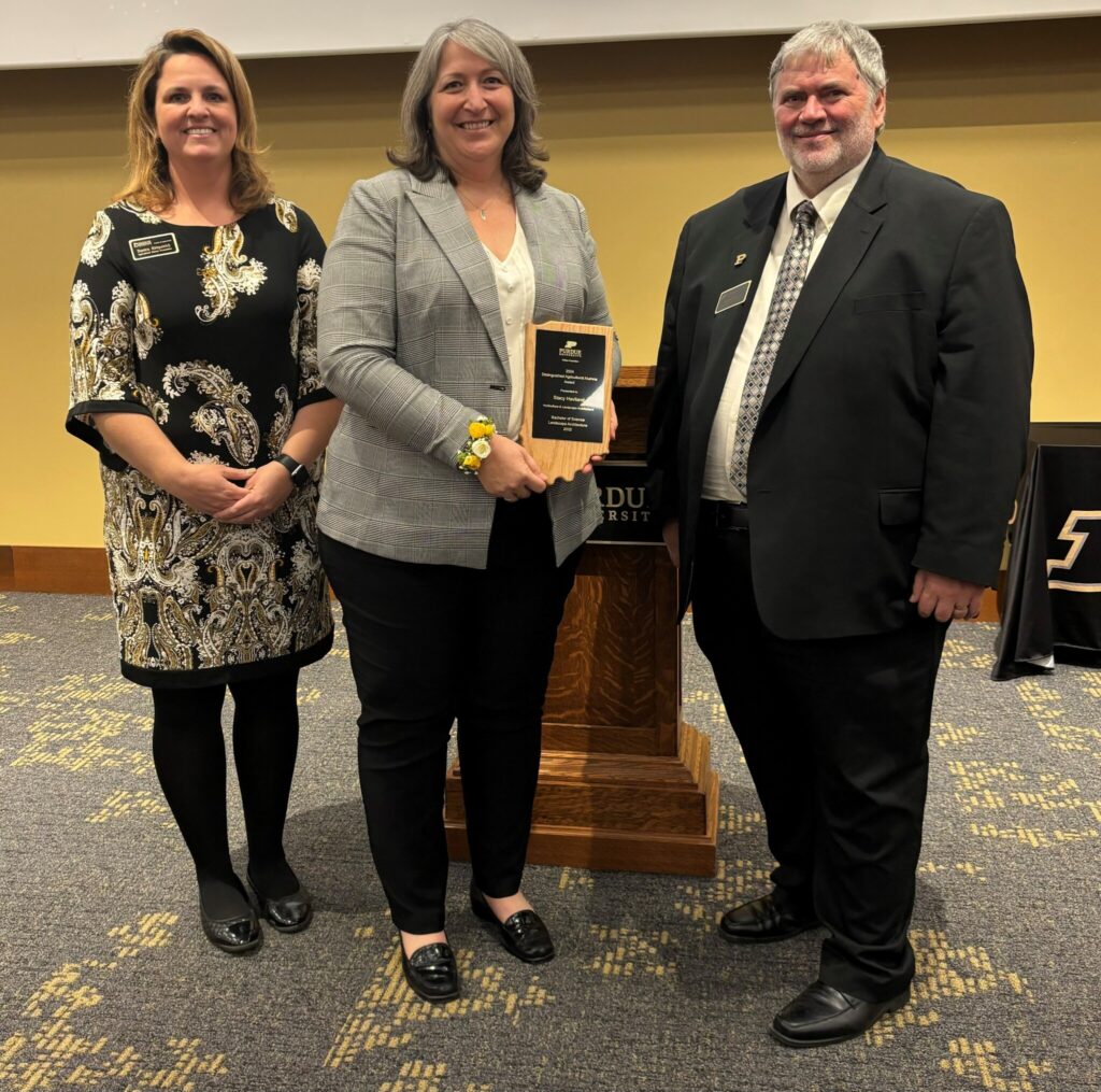 Stacy Haviland holding Distinguished Alumni Award with Ag Dean Bernie Engle and Danica Kirkpatrick (Ag Alumni Relations).