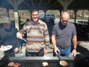 Three men at the grill.