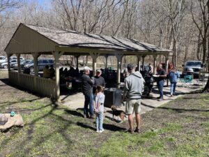 People milling about at the picnic shelter.